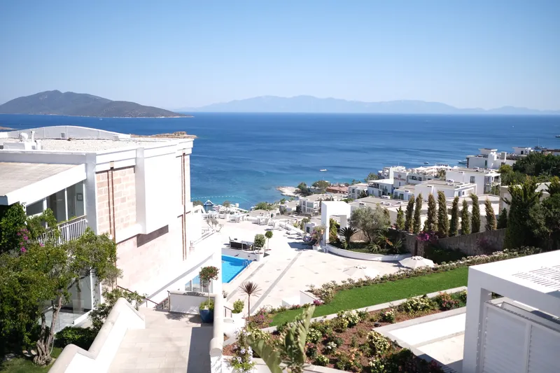 Guests enjoying a beautiful Bodrum villa wedding ceremony surrounded by lush gardens and luxurious amenities.