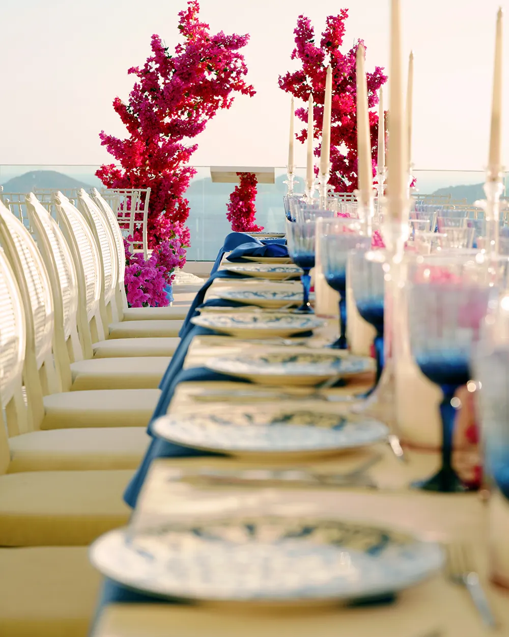 Pink floral wedding table design with blue glassware at a private villa in Kalkan