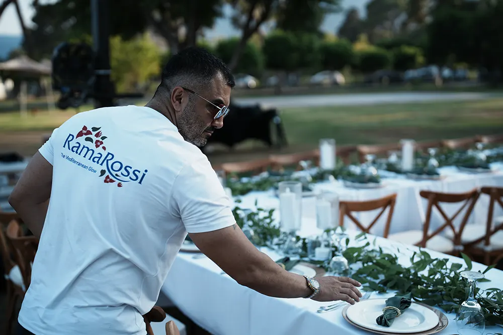 Hakan Turan checking a wedding reception table setup before a Ramarossi event