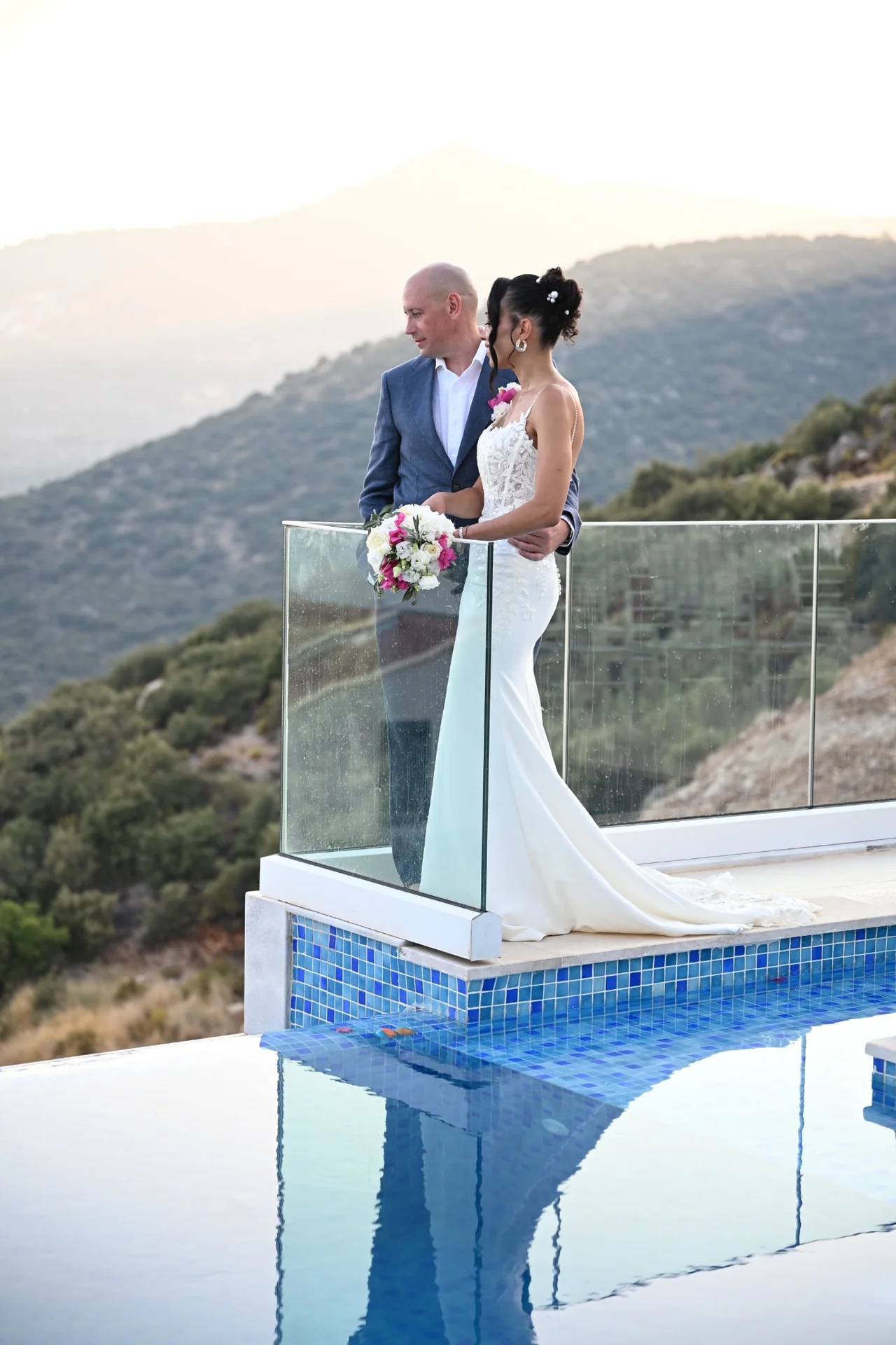 Bride and groom at a private villa wedding in Kalkan, beside an infinity pool with a mountain view