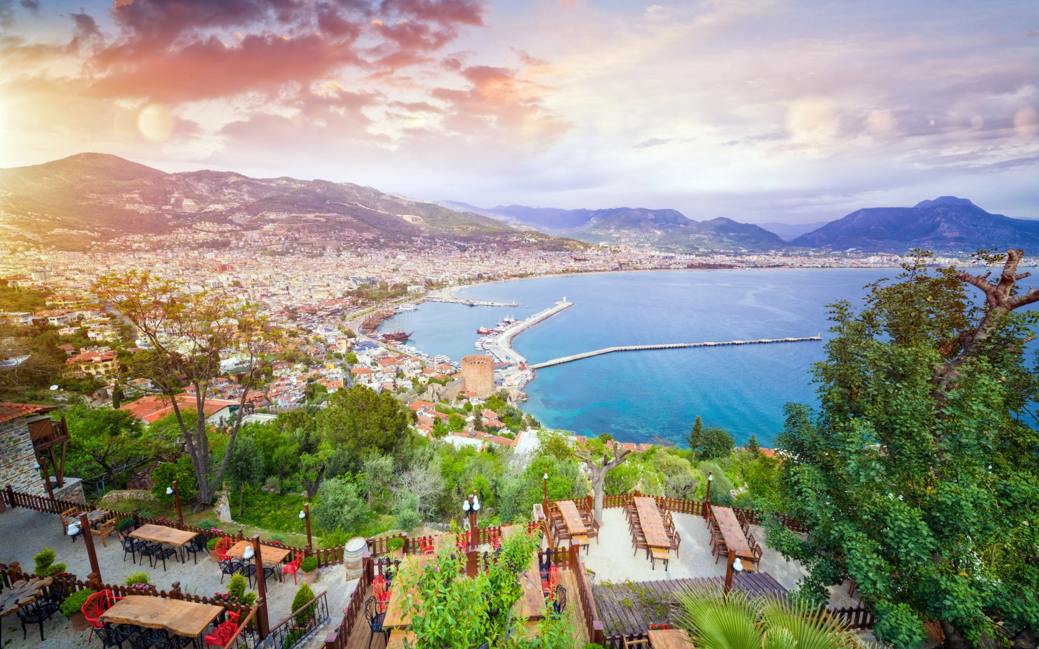 Panoramic view across Alanya's Mediterranean bay and harbour at sunset.