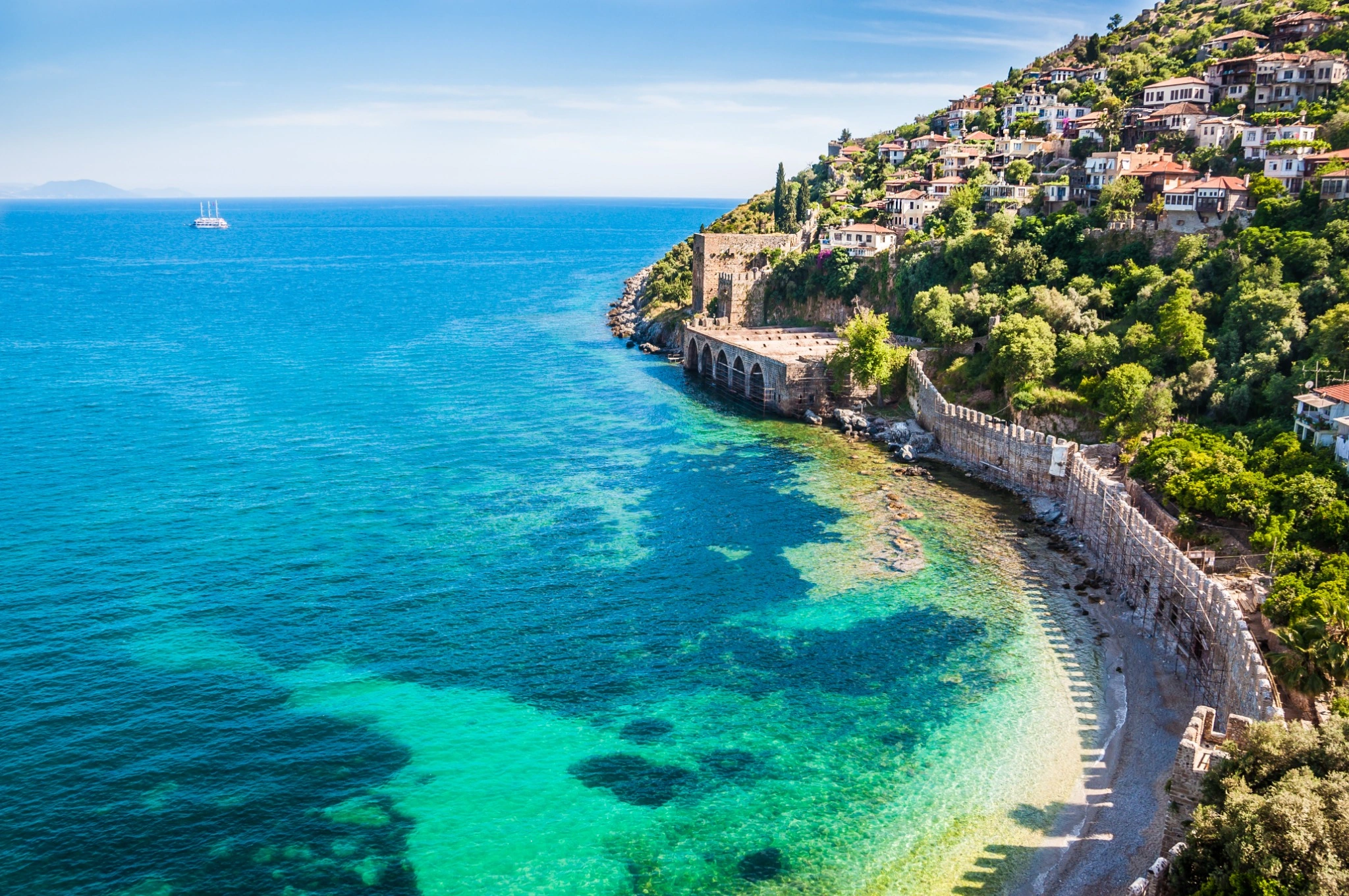 Alanya Castle walls overlooking the turquoise Mediterranean coast.