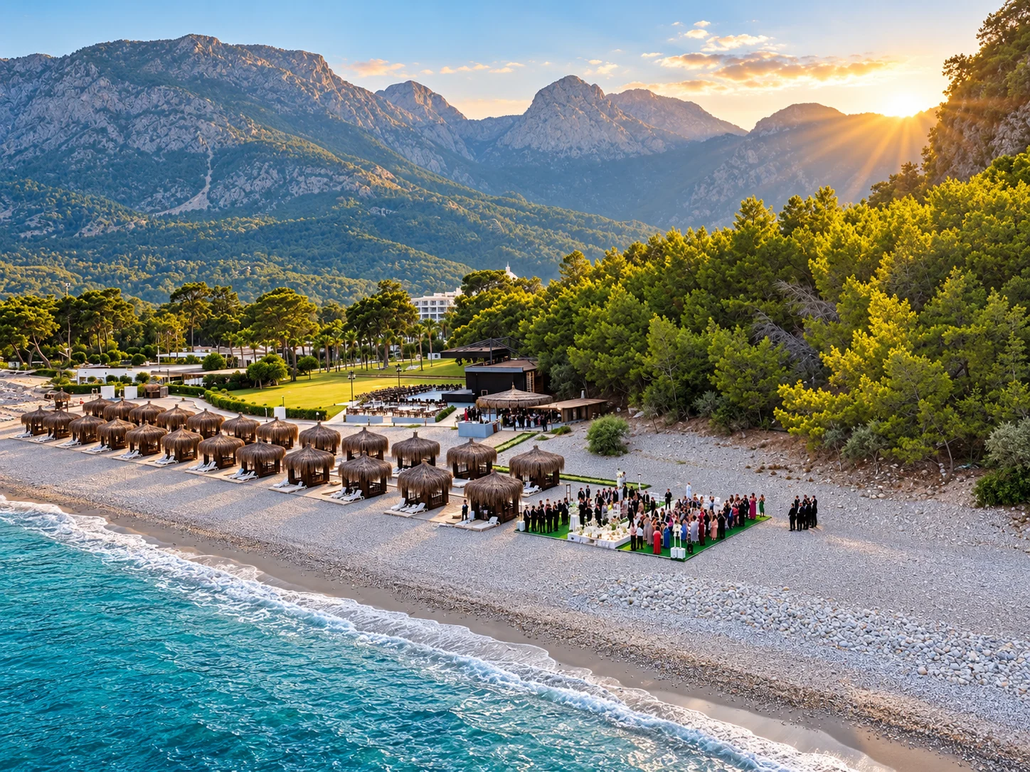 Aerial view of a wedding ceremony on an Antalya beach surrounded by the Mediterranean coast and green hills.
