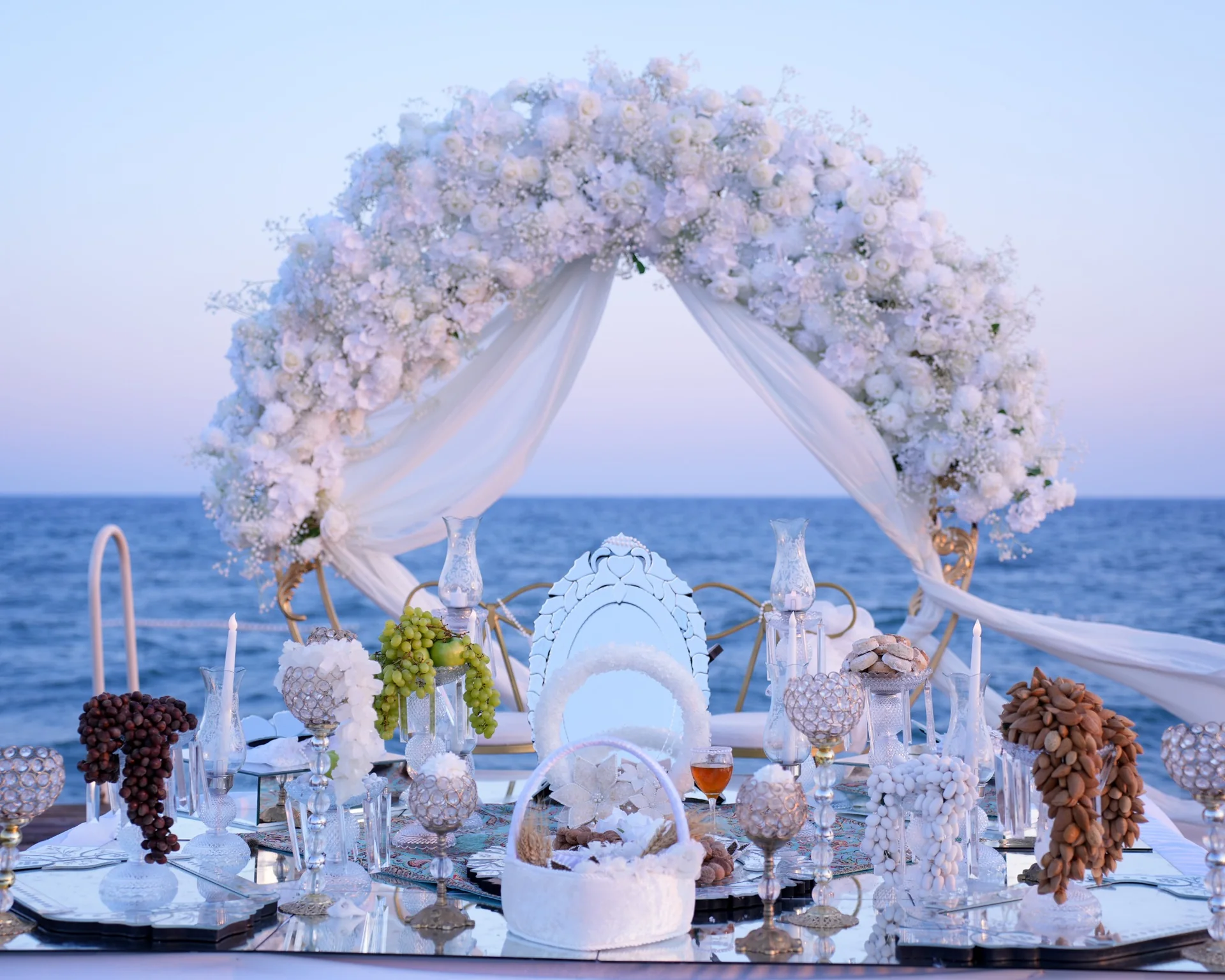 White floral Sofreh Aghd wedding ceremony setup overlooking the sea in Antalya