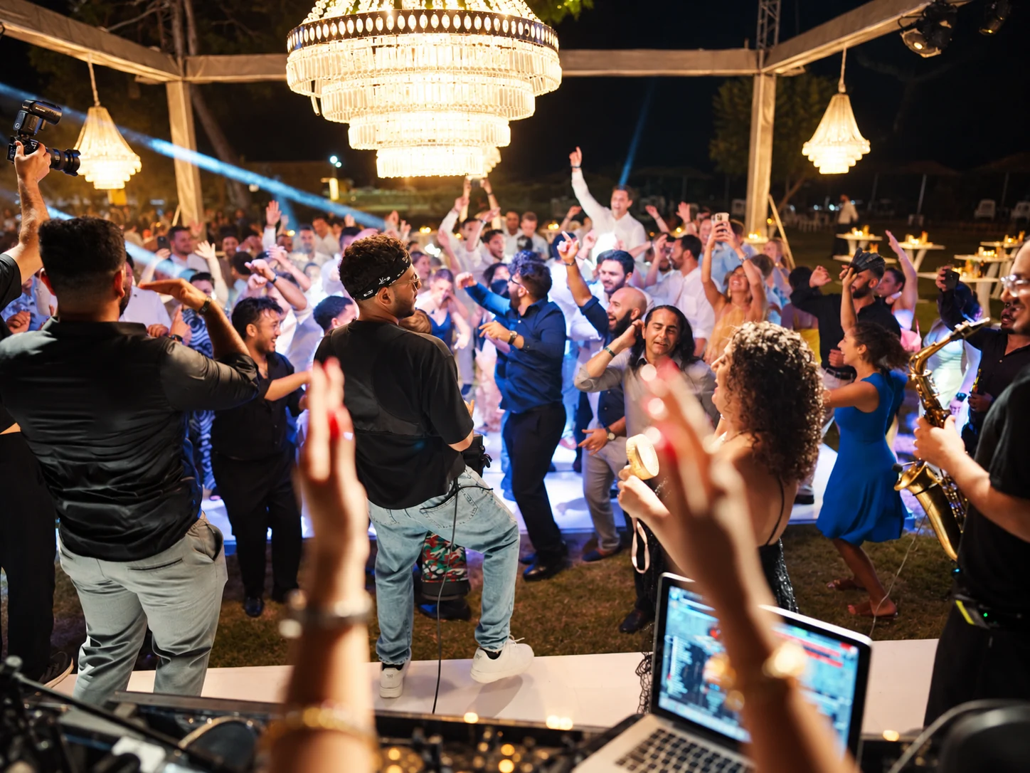 Guests dancing during an outdoor Persian wedding celebration with live entertainment in Antalya